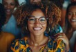 © ANUAR - Smiling Woman with Curly Hair and Glasses in Colorful Outfit Surrounded by Friends, Capturing Joy and Connection in a Lively Setting