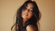 © liliyabatyrova - Under warm lighting, a graceful Latina woman showcases her long wavy hair, embodying confidence and elegance in a captivating pose. Her alluring expression invites admiration