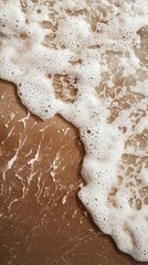 Poster - Gentle waves touch the mocha sands, creating a delicate foam as the sun casts a warm glow. The moment captures the tranquil beauty of a coastal paradise
