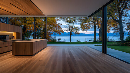 Poster - A modern kitchen opens to a serene lakeside view, framed by large glass windows, showcasing autumn foliage and a peaceful outdoor landscape