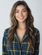 © jirayut - Smiling woman in cozy flannel pajamas exuding confidence and warmth