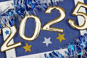 Wall Mural - golden numbers 2025 two thousand twenty five new year with blue, white tinsels and stars and white frame on glitters blue background