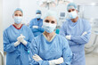 © peopleimages.com - Teamwork, doctors and portrait with arms crossed for theater, medical surgery or procedure for staff. Hospital, surgeons and woman leader with pride for operating room, career or face mask for safety