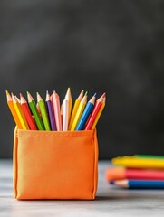 Wall Mural - Vibrant Colorful Pencils in Organizer - A bright orange pencil holder filled with assorted colored pencils ready for artistic creativity and learning.