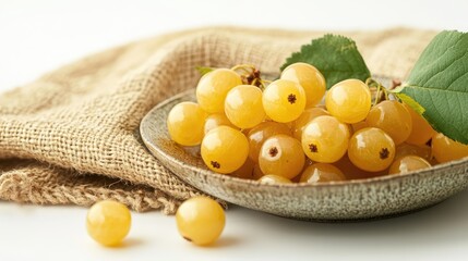 Aufkleber - Ripe yellow cherry berries on ceramic plate with jute bag background showcasing freshness and natural beauty in macro shot