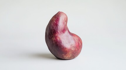 Poster - Unique red potato tuber with a distinctive shape isolated on a clean white background highlighting its organic features and colors