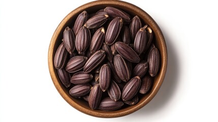 Poster - Tonka beans displayed in a wooden bowl on a white background showcasing their unique shape and rich brown color from a top-down perspective