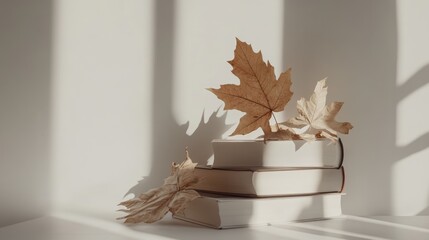 Aufkleber - Minimalistic home interior featuring vintage books and dried leaves on a white background with natural light shadows and ample copy space