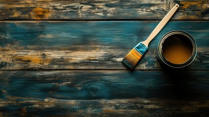 Poster - Top view of paint brush beside an open can on a wooden table showcasing a painting and renovation theme with copy space.
