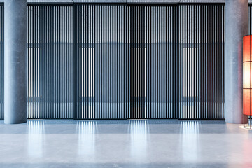 Poster - Modern interior with vertical black slatted walls, polished concrete floor, and a red accent lamp on the side. 3D Rendering