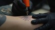 © vitanovski - Close-Up of Tattoo Artist Creating a Sun Design on Arm
