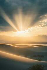 Sticker - Sunbeams illuminate desert dunes and distant mountains.