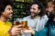 © Xavier Lorenzo - Happy multiracial young friends having fun together drinking beer at brewery bar - Millennial people celebrating toasting alcohol drinks at restaurant