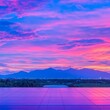 © Big9869 - Vibrant sunset over cityscape and mountains reflected on a tiled surface.