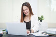 © NanSan - A young, professional businesswoman working at her desk in an office, providing online legal consultancy for disputed civil cases, addressing lawsuits, loan defaults, unfair dismissals, and property