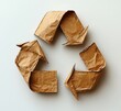 © typepng - A top view of a recycling symbol cut from kraft paper on a white background.
