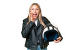 © luismolinero - Young pretty blonde woman with a motorcycle helmet over isolated chroma key background with surprise and shocked facial expression