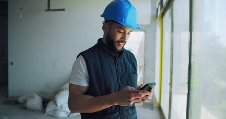 Poster - Man, architect and typing with phone for construction, planning project or development. Happy engineer, mobile and builder at site for communication, text or maintenance for infrastructure renovation