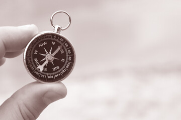 Wall Mural - round compass in hand on abstract background