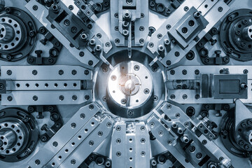Fototapete - A complex machine with many parts and a bright light shining on it. The light is located in the center of the machine, illuminating the intricate design