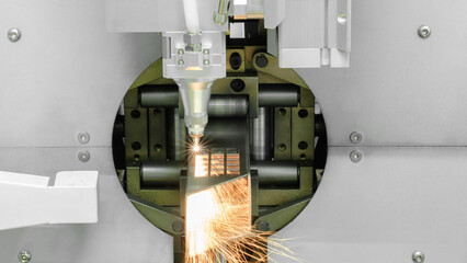 Poster - Close up scene the fiber laser cutting machine cutting  machine cut the stainless steel tube. The hi-technology sheet metal manufacturing process by laser cutting machine. technical concept