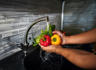 Aufkleber - Hands rinse colorful bell peppers and cucumbers under kitchen faucet.  Fresh produce, healthy eating preparation.