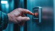 © familymedia - A close-up of someone pressing an elevator button that is glowing red in a modern, stainless steel panel, indicating the activation of the elevator call.