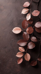 Poster - Delicate mocha-colored leaves rest beautifully on a textured dark surface, showcasing nature's elegance in harmony with the earthy tones