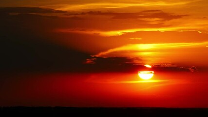 Wall Mural - timelapse with dramatic red sunrise on dark cloudy sky, 4k