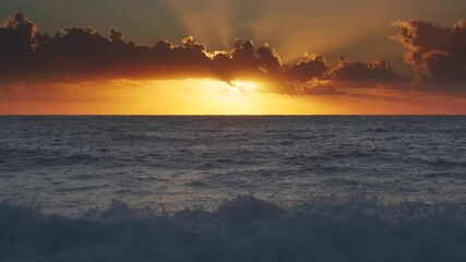 Wall Mural - stunning sunset over sea waves with vibrant colors reflecting on the water at the beach, 4k