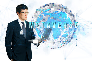 Poster - Businessman in suit holding laptop with digital holographic globe and Metaverse text, on white background, representing virtual technology