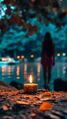 Wall Mural - Woman stands by a serene lake at dusk with a glowing candle illuminating the foreground and reflections shimmering on the water