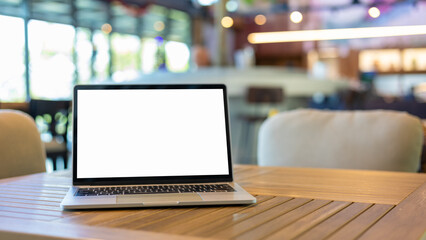 Poster - Laptop with blank screen and placed on a wooden table inside a coffee shop. Workspace background new project on laptop computer with blank copy space screen for your advertising text message.