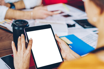 Fototapete - Cropped image of female hands typing text with finger on copy space display on modern touch pad.Young woman doing shopping online using wireless 4G internet connection on tablet with blank screen