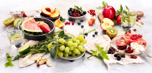 Wall Mural - Fruit assortment served on light gray table.