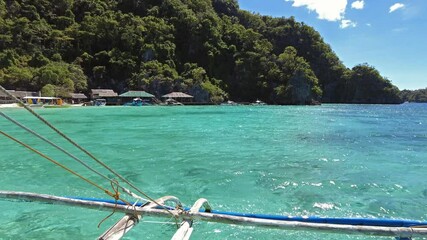 Wall Mural - tropical philippines island, view from moving boat. white sand beach, rocks cliffs mountains and blu