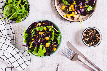 Wall Mural - Red cabbage, corn and arugula salad in a bowl on the table top view