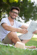 © auremar - businessman reading the newspaper siting in a park