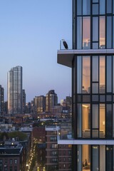 Wall Mural - Eagle perched on a modern building balcony overlooking a city at dusk. AI.