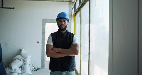 Poster - Builder, face and man with arms crossed for construction site progress or project management. Happy, engineering or confident contractor with helmet for building safety, labor or structure inspection