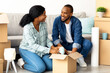 © Prostock-studio - Happy young african american couple moving to new apartment, packing belongings to cardboard boxes and smiling to each other, cheerful black spouses enjoying relocation to own flat, closeup