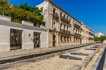 Wall Mural - A row of old buildings with a white fence in front of them