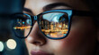 © Andres Mejia - Businesswoman wearing glasses reflecting city skyline at night