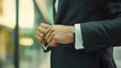 © mahamad - A businessman adjusting his cufflinks.