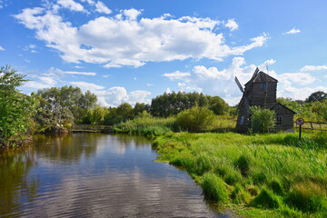 Wall Mural - Ancient windmill on the bank of a pond in Ertil village