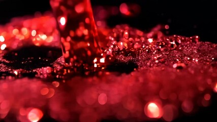 Poster - Dynamic drops of red glitter in black oil or ink diffusing through liquid, creating an abstract aquatic swirls