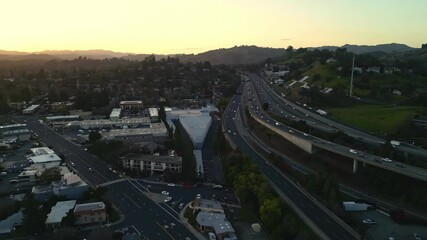 Wall Mural - Walnut creek at sunset with busy highways and surrounding hills in california , aerial view