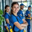 © GoodandEvil - Team smiling in blue uniforms with cleaning tools ready