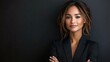 © zhuan - Confident Businesswoman in Black Suit Highlighting Strength and Poise in a Professional Environment