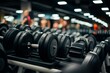 © SnapScape - Dumbbells arranged in gym, people walking nearby